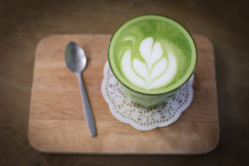 green tea latte on wood background