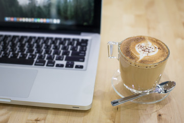 Hot art Latte Coffee in a cup on wooden table and Coffee shop bl