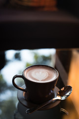Hot art Latte Coffee in a cup on wooden table.