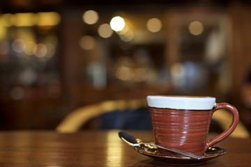 Hot art Latte Coffee in a cup on wooden table.