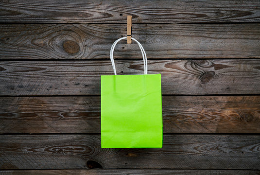 green Shopping bag on a wooden background, sale, purchase
