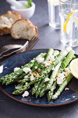 Warm salad with asparagus, feta cheese and lemon