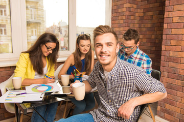Young joyful team working with a business project