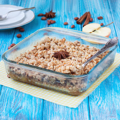 Apple crumble dessert on wooden background