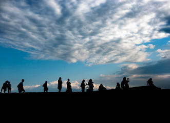 silhouettes of people admiring sunrise