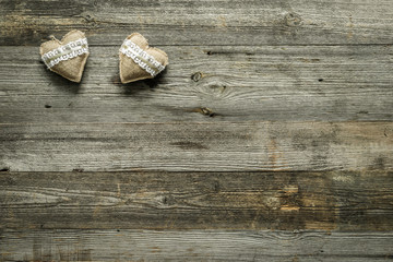 two hearts on old wooden background