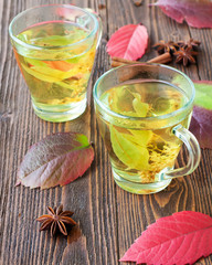 Cup of linden tea on wooden background