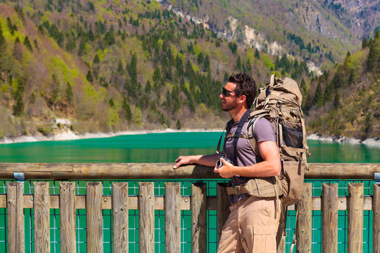 hiker with backpack at the lakeside
