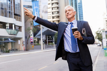 Businessman catching taxi in city