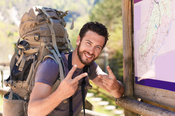 Smiling hiker doing the V sign - 98371044