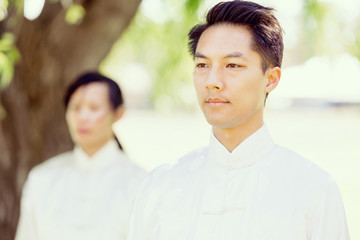 Handsome man practicing thai chi