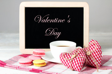 Cup of coffee and a decorative heart with a cake and plaque for writing the text on a white background isolated