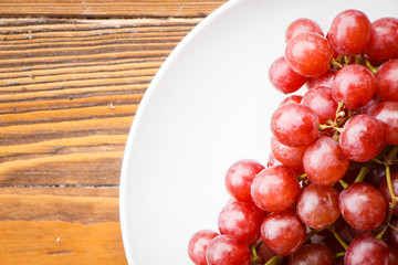 Red grape on wooden table, Healthy concept.