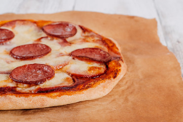 Baked homemade pizza on baking paper