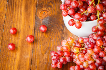 Red grape on wooden table, Healthy concept.