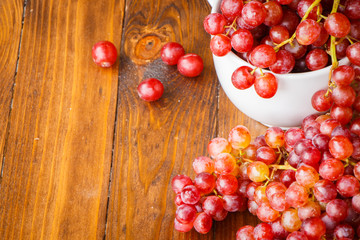 Red grape on wooden table, Healthy concept.