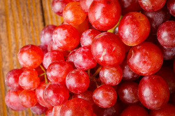 Red grape on wooden table, Healthy concept.