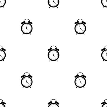 Seamless vector pattern. Symmetrical background with black alarm clocks on the white background.