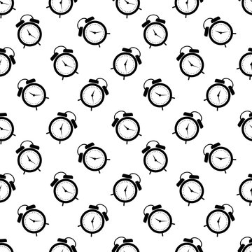Seamless vector pattern. Symmetrical background with black alarm clocks on the white background.