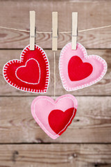 Clothesline with Valentine's Day hearts decorations on a rustic