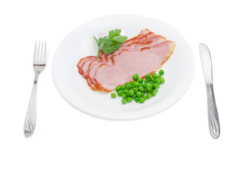 Sliced ham with green peas