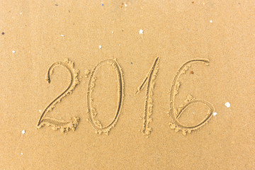 2016 Year written on the beach sand