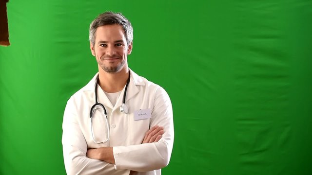 green background, a male doctor in uniform with a stethoscope