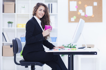 Beautiful business woman working on computer. Woman in her office, shallow depth of field