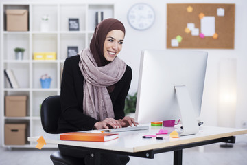 Beautiful Arabic business woman working on computer. Woman in her office
Shallow depth of field.