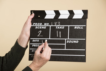 Woman holding a clapper board