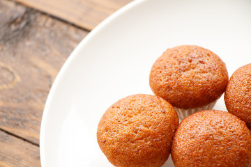 Banana muffin cake on white plate put on wooden table.
