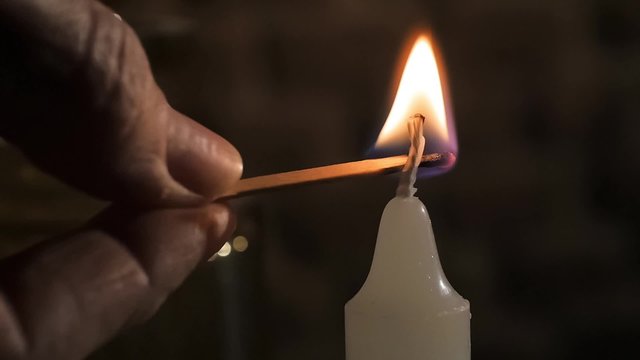 lighting up a wight candle, close up
