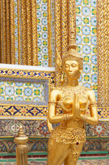 Gold Kinnaree statue, Thai angel woman at Wat Phra Kaew temple in Bangkok Thailand.