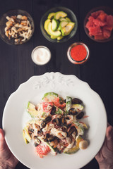 Seafood salad in the hand with blurred ingredients top view