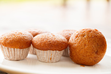 Banana muffin cake on white plate put on wooden table.