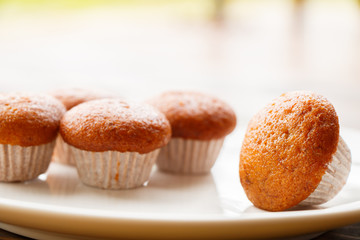 Banana muffin cake on white plate put on wooden table.