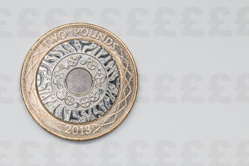 Two Pound coin on a paper background