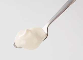 White yogurt on a spoon