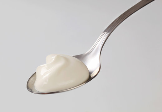 White yogurt on a spoon