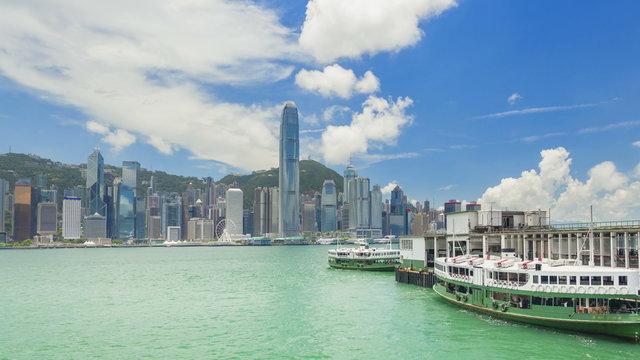 4k timelapse video of ferry terminal and Victoria Harbour in Hong Kong, camera zooming in