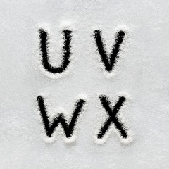 Winter alphabet, symbols and numbers hand written on snow.