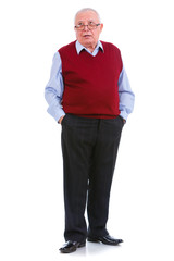 Thinking senior old teacher man with glasses, holds hands in pockets, cardigan marsala color and shirt, isolated on white background. Human emotions, facial expressions. Education concept
