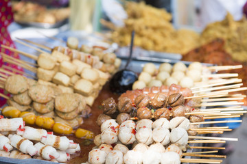 fried meatballs with spicy sauce at market