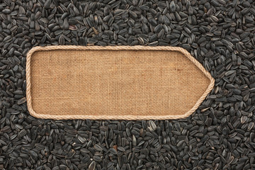Pointer made from rope with sunflower seeds  lying on sackcloth