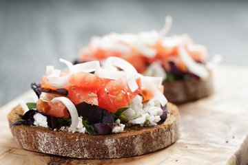 rye sandwich or bruschetta with ricotta, herbs and tomato