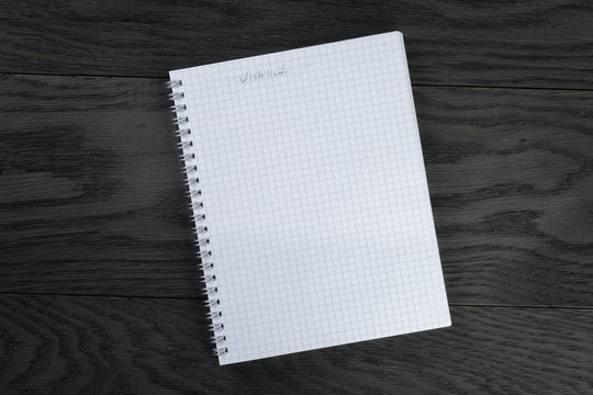 Blank Notepad With Wishlist On Gray Wood Table