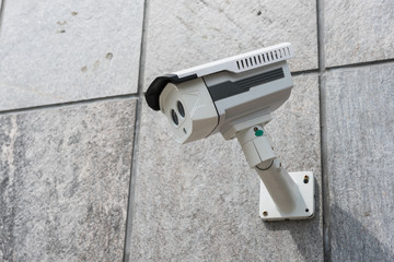 CCTV security camera on stone wall
