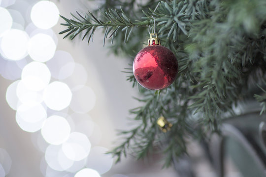 Christmas tree decorated with toys. Ball hanging on a branch of a tree. 