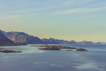 Breathtaking view from top of a mountain over islands in Norway at sunset 