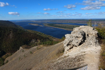 Fototapeta na wymiar View from Strelnaya Mountain at Zhiguli Mountains and the Volga River against a blue sky
